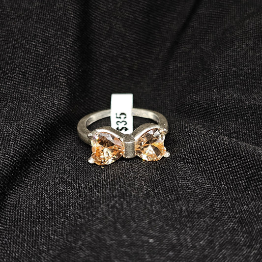 Bow Design Champagne Gemstone Ring in Silver Tone – Size 6